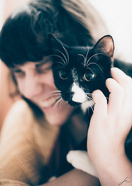 Cat with person in the background.